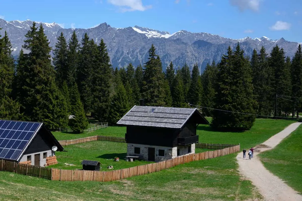 tiny home with solar panels in a rural setting with mountains