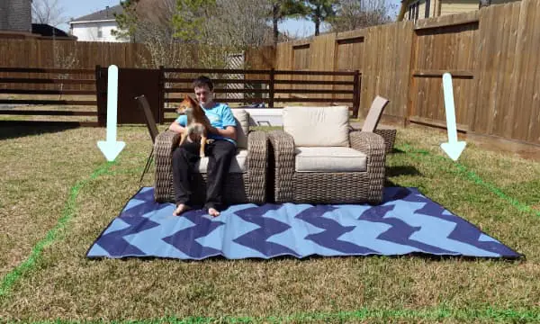 12 x 16 rectangle spray painted onto grass with patio furniture, boy, and dog shown to illustrate items in a pretend tiny house