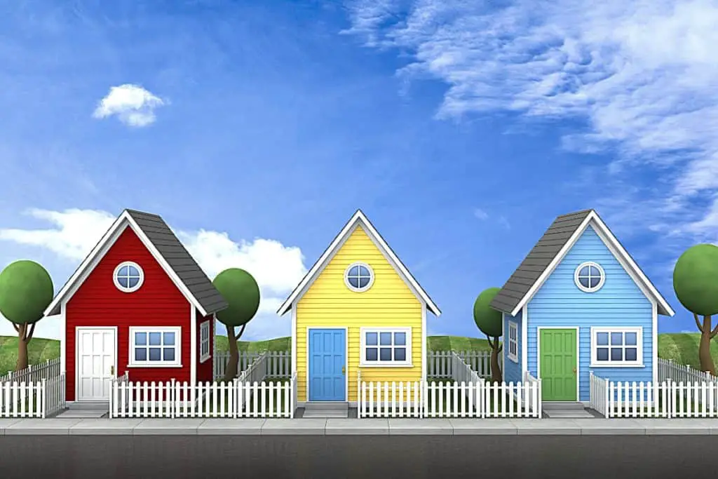 3 tiny houses with picket fences. 
